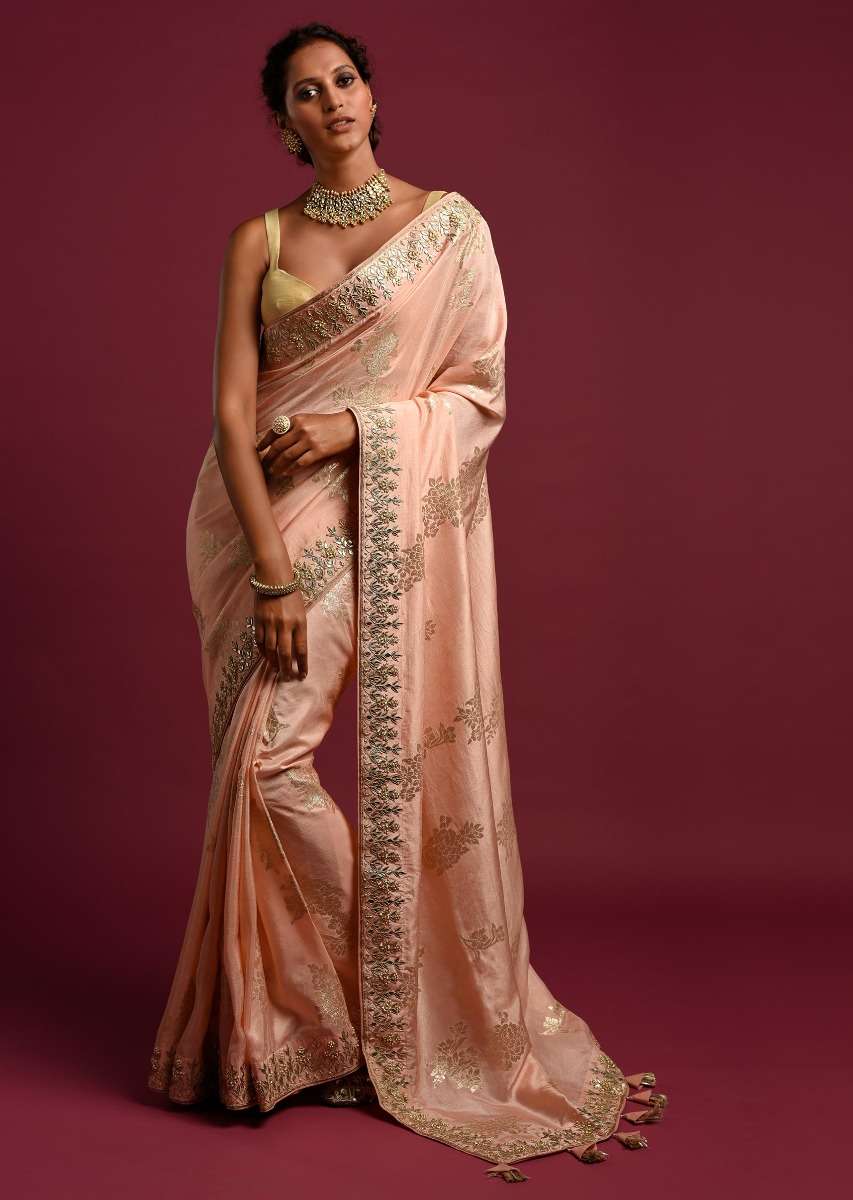 Powder Peach Banarasi Saree With Weaved Floral Motifs And Embroidered Border